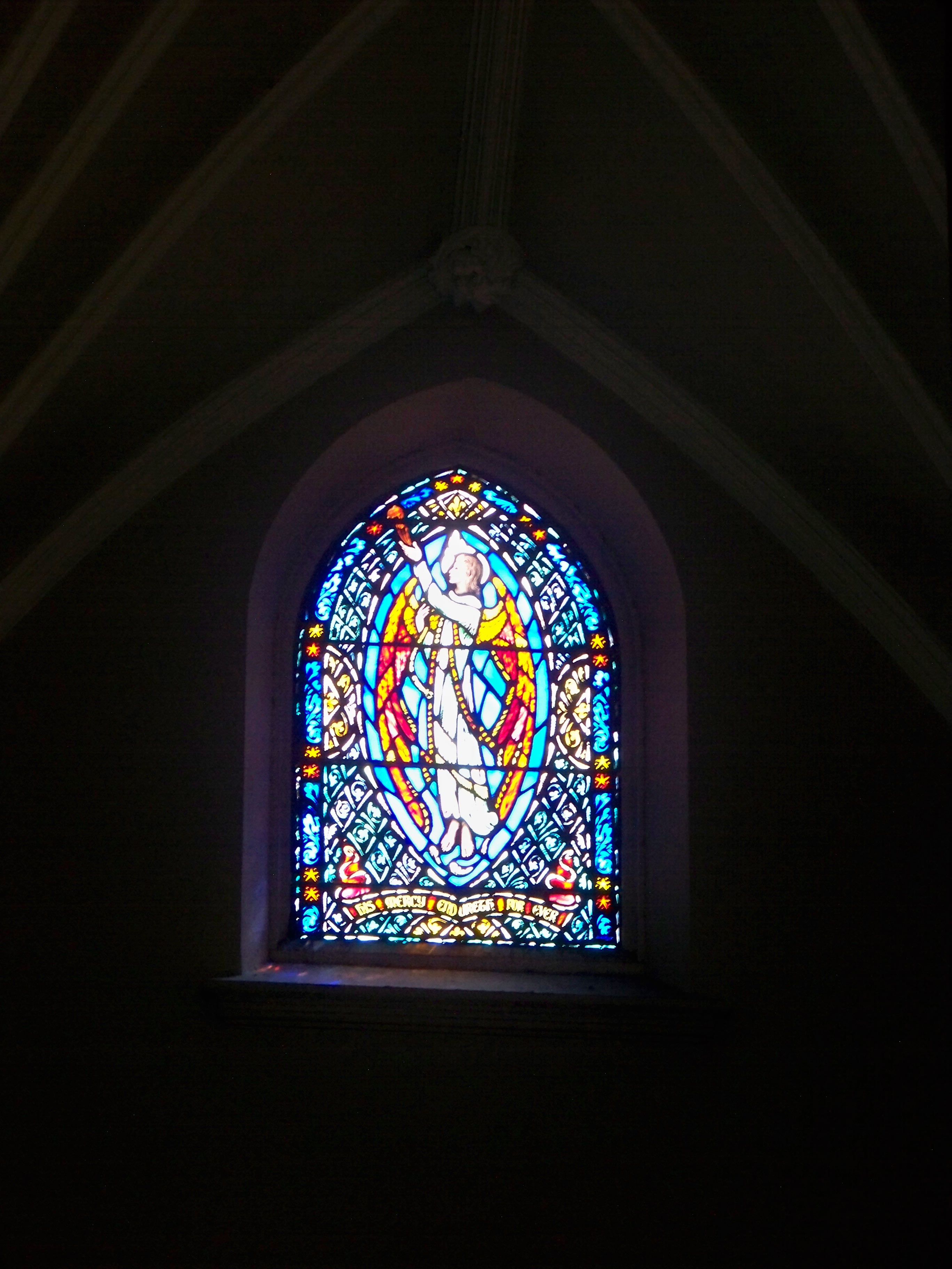 Small stained glass window towards the back of the church